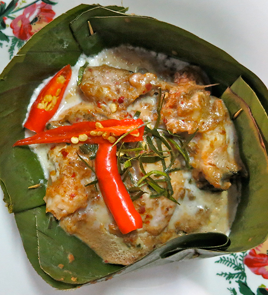 Mok Plaa Suai - Suai fish wrapped in banana leaf and wood-charred.